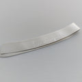 Metallic object with engraved text on a gray background
