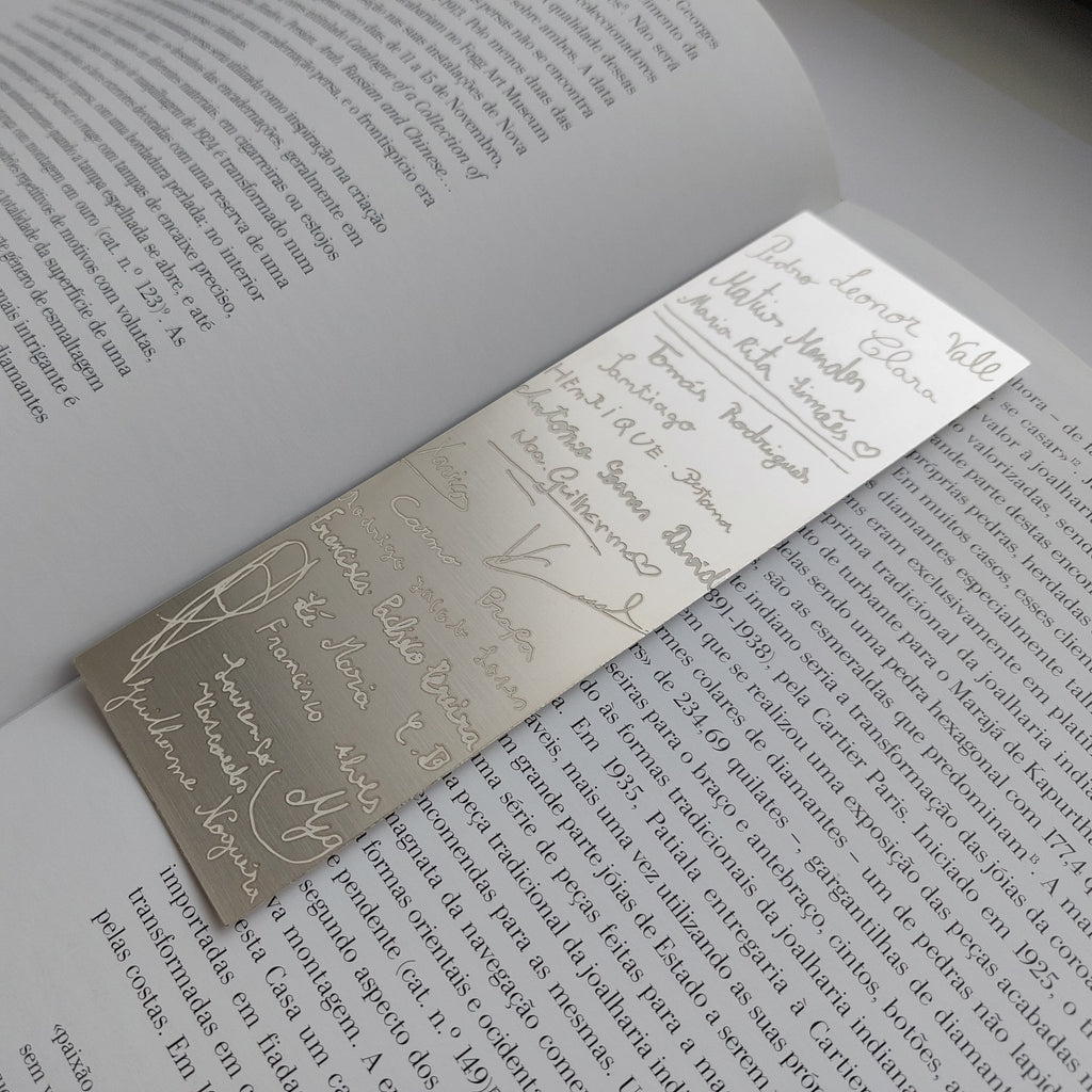 Metallic bookmark on an open book with text