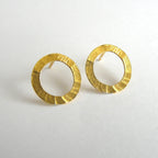 Pair of gold hoop earrings on a light gray background