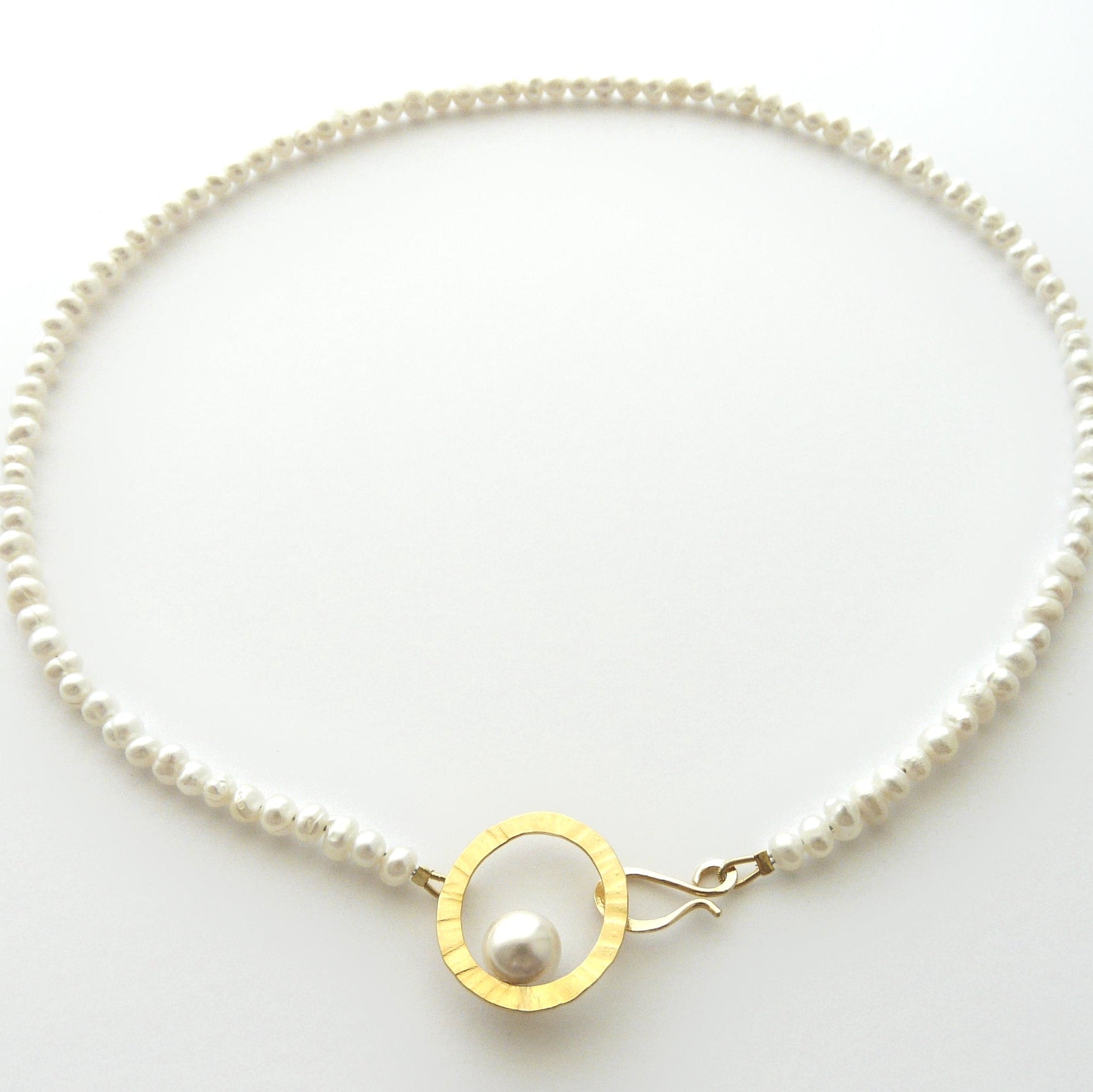 Pearl necklace with a gold clasp on a white background