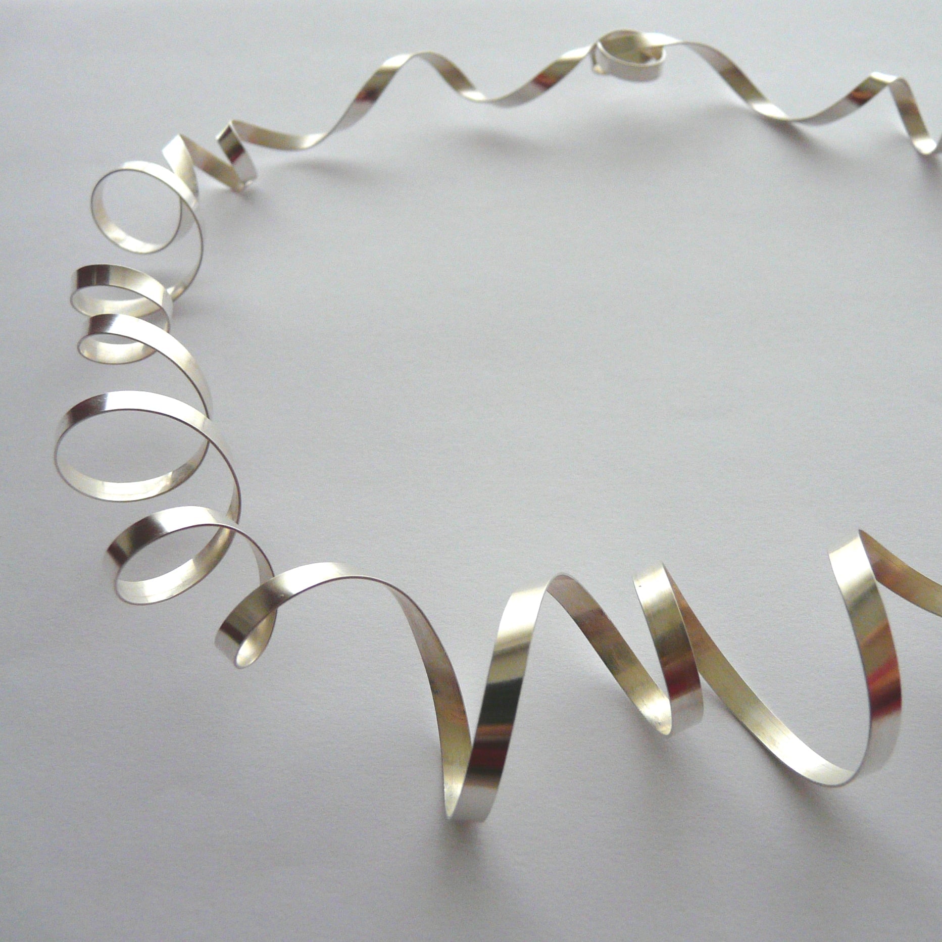 Silver metallic wreath on a light gray background