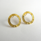 Pair of gold hoop earrings on a light gray background